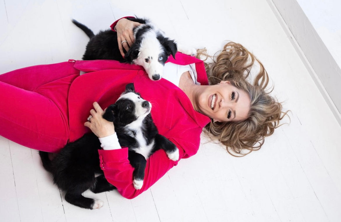 Geralynn laying down with two puppies